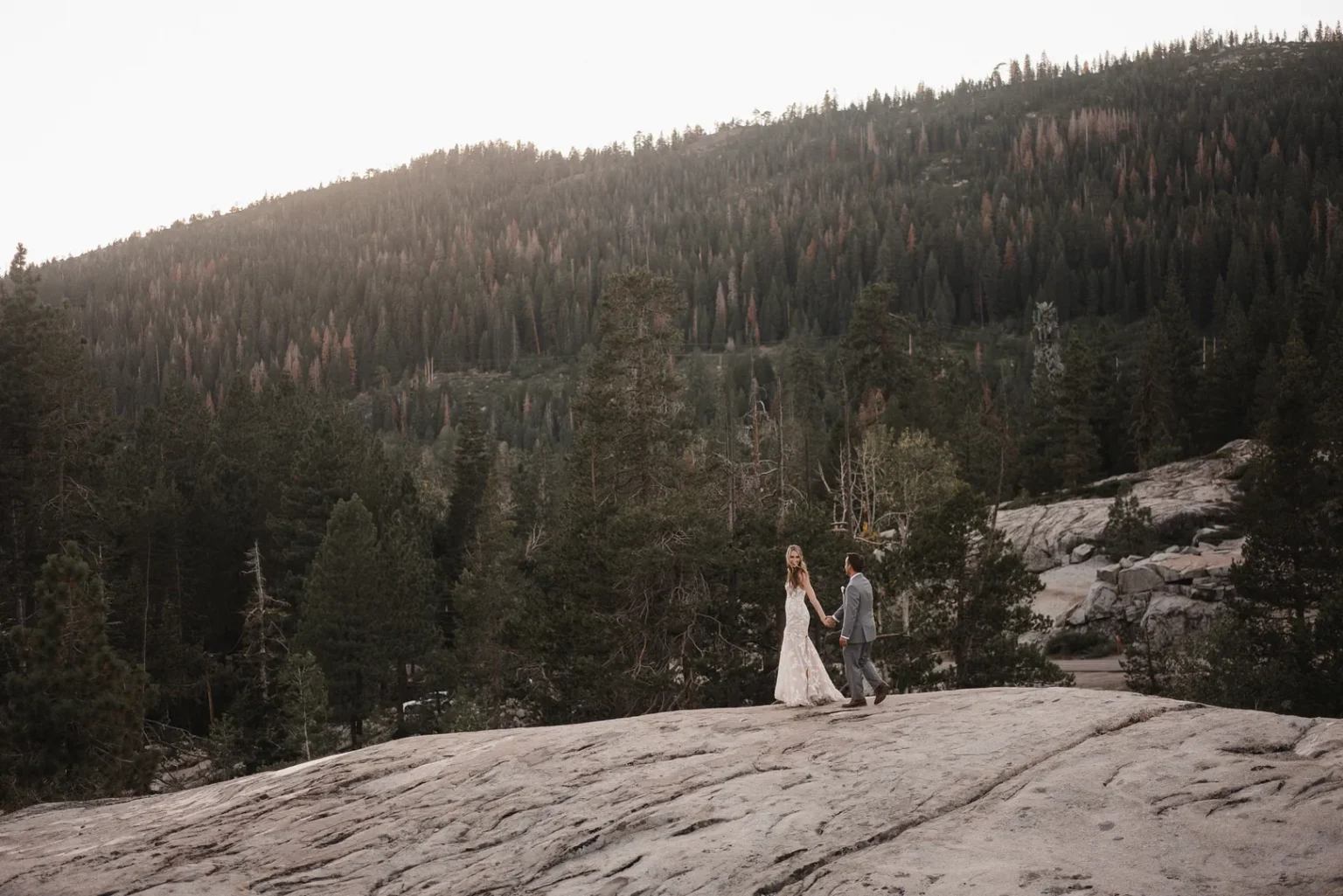 couple during golden hour holding hands at rainbow lodge